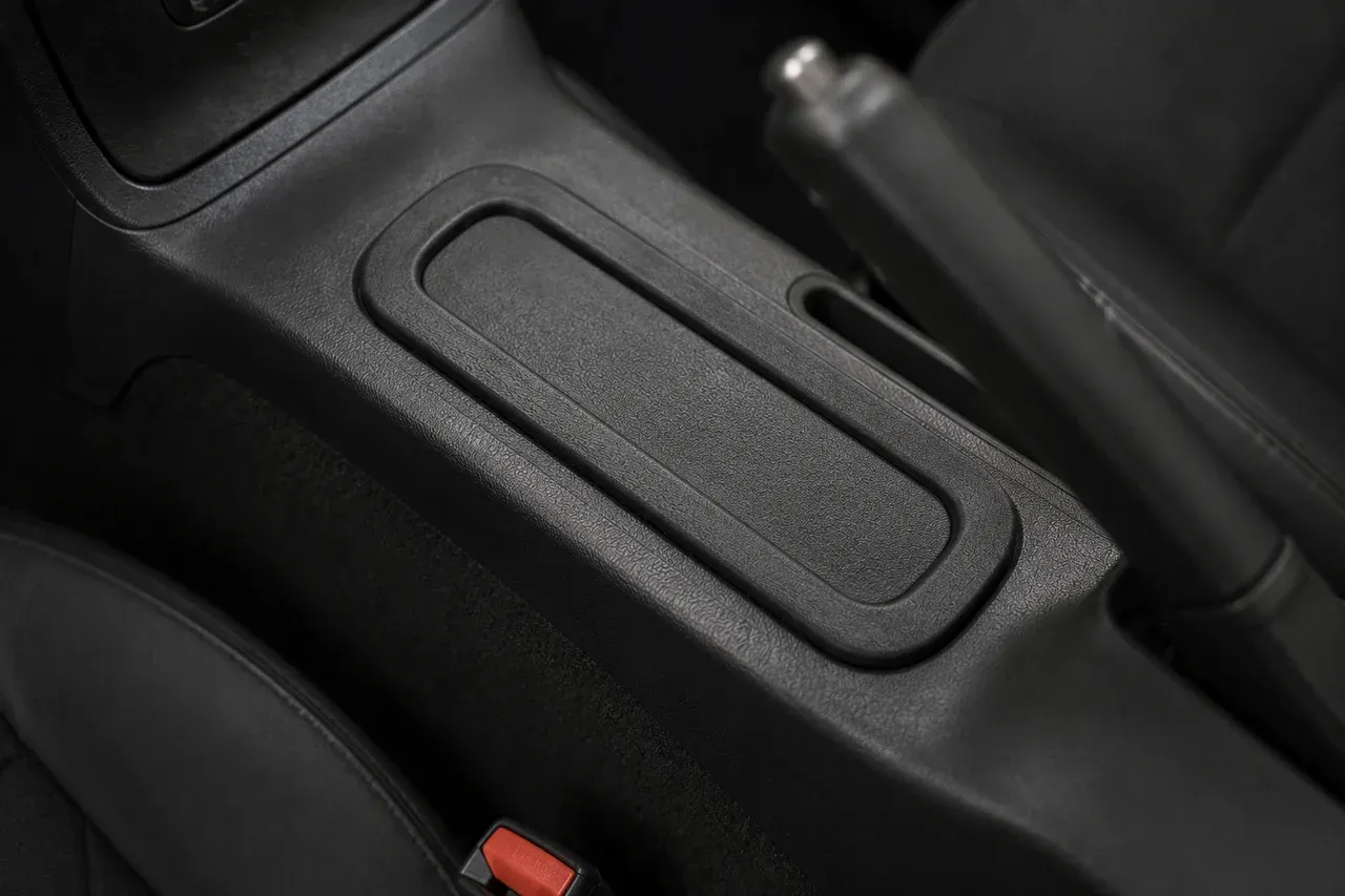 The printed center console cupholder lid fitted in place in a car interior