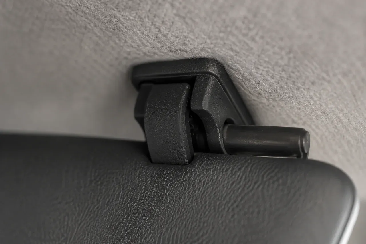 The printed sun-visor clip pair fitted in place in a car interior