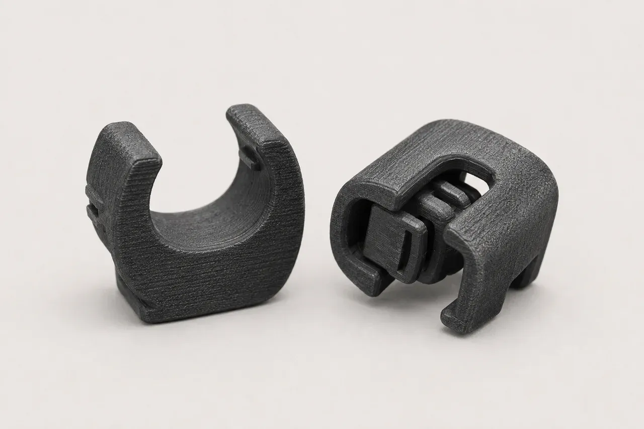 3D-printed reproduction of the sun-visor clip pair for the 1985-1991 Porsche 944, studio view