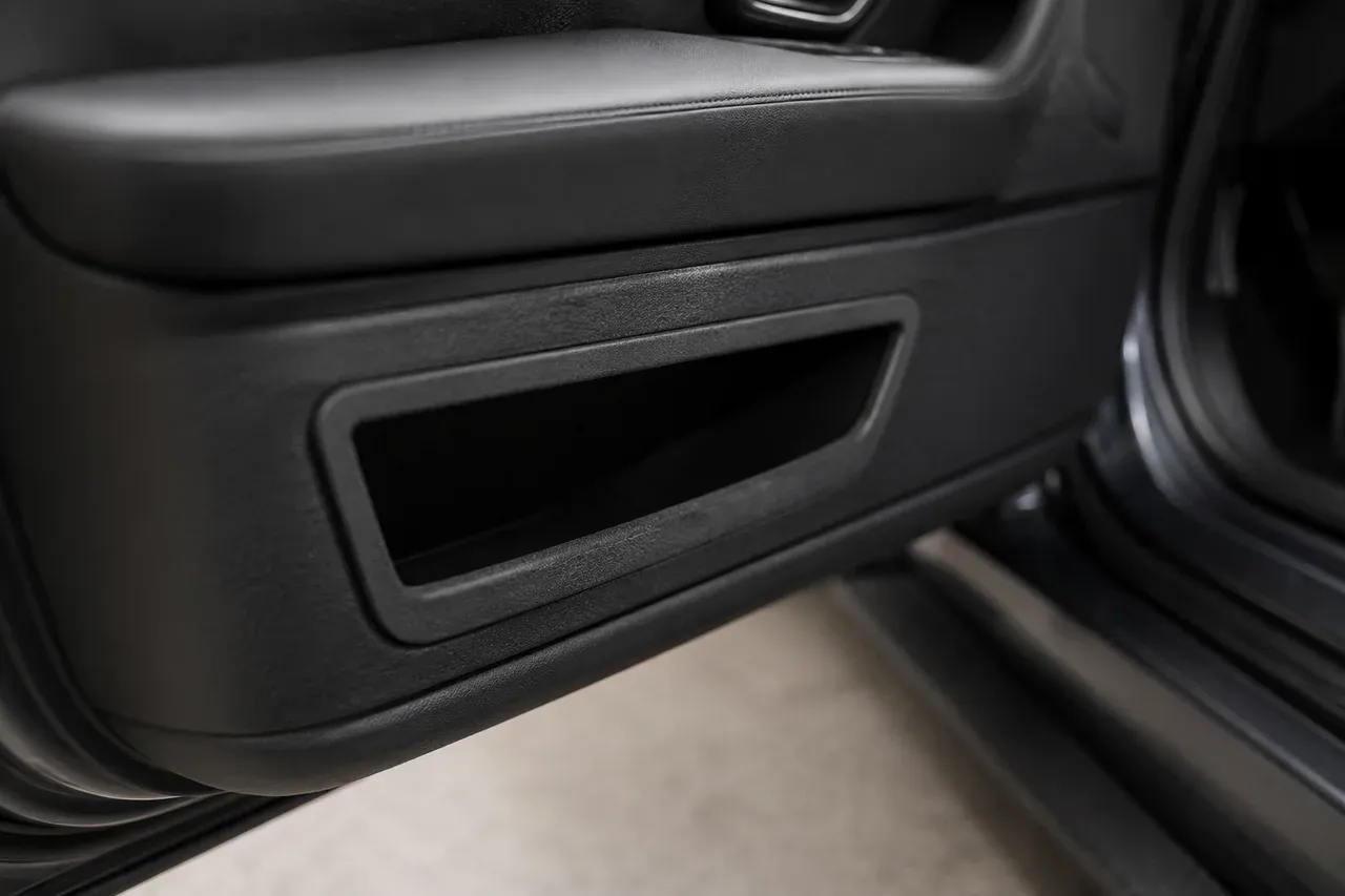 The printed door card map-pocket trim fitted in place in a car interior